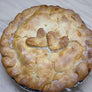 Chicken pot pie with a decorative crust in a cardboard box